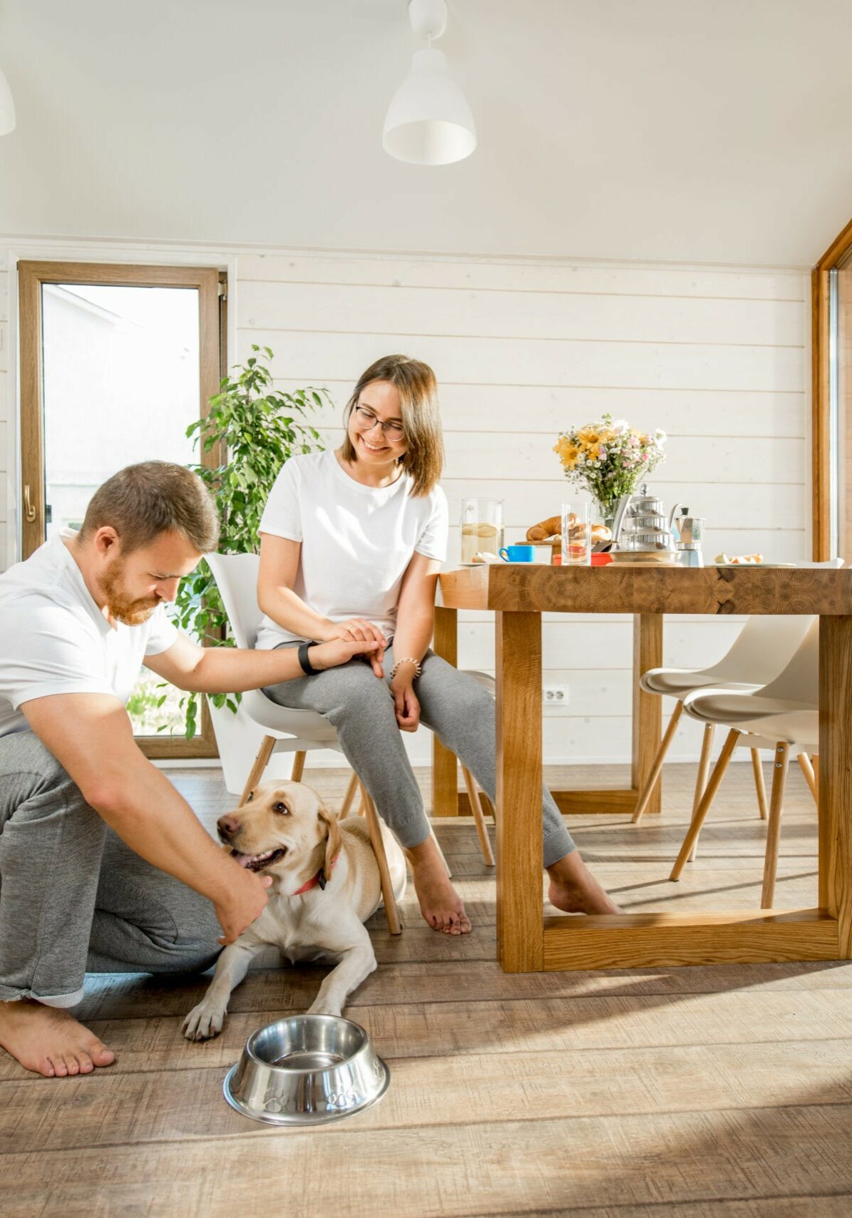 Young couple with dog at home | JD Owens Carpet & Ceramic Outlet