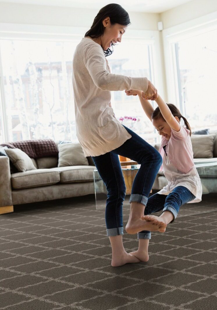 Girl playing with mom | JD Owens Carpet & Ceramic Outlet